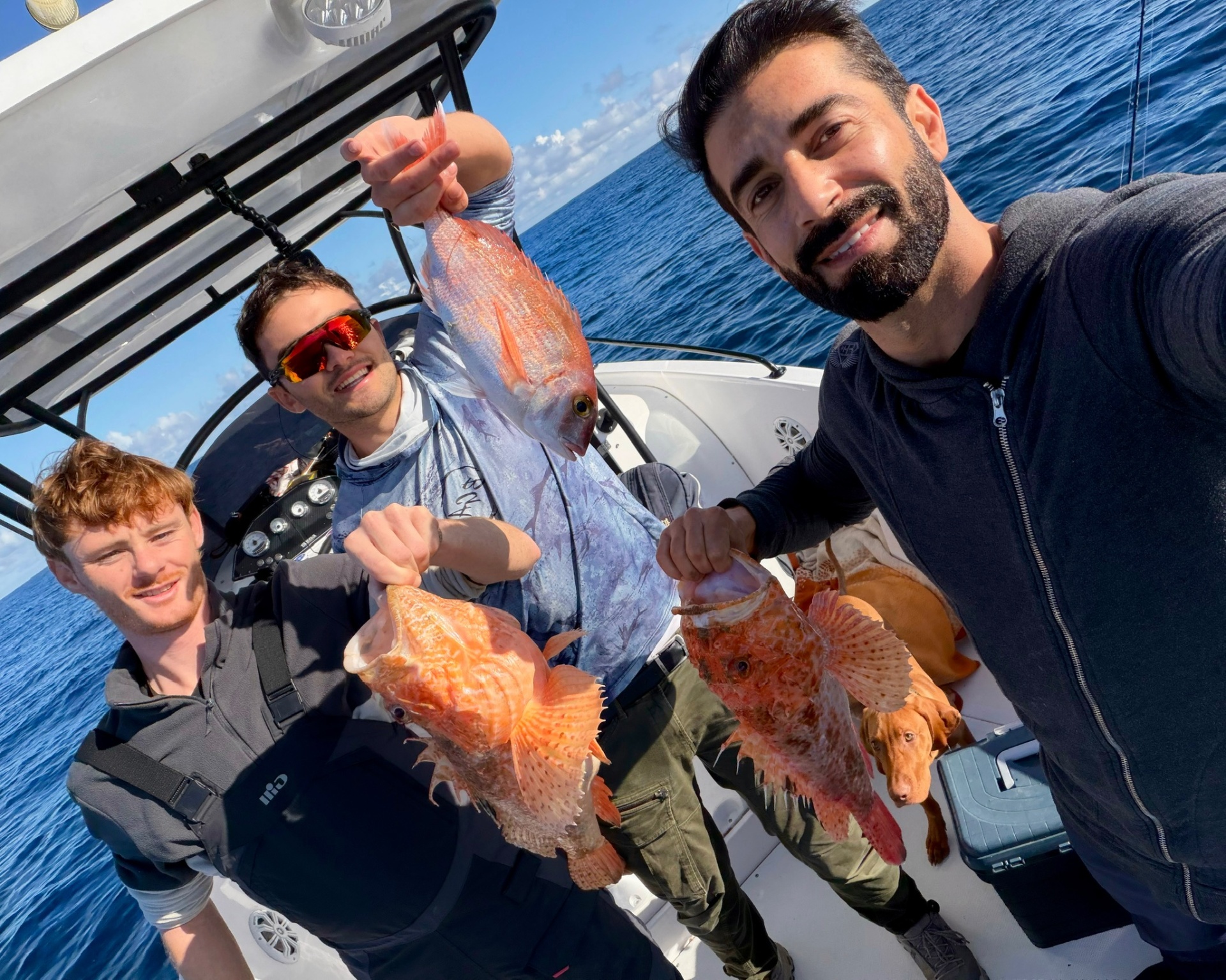 Angler holding a large red snapper caught winter bottom fishing in Malta